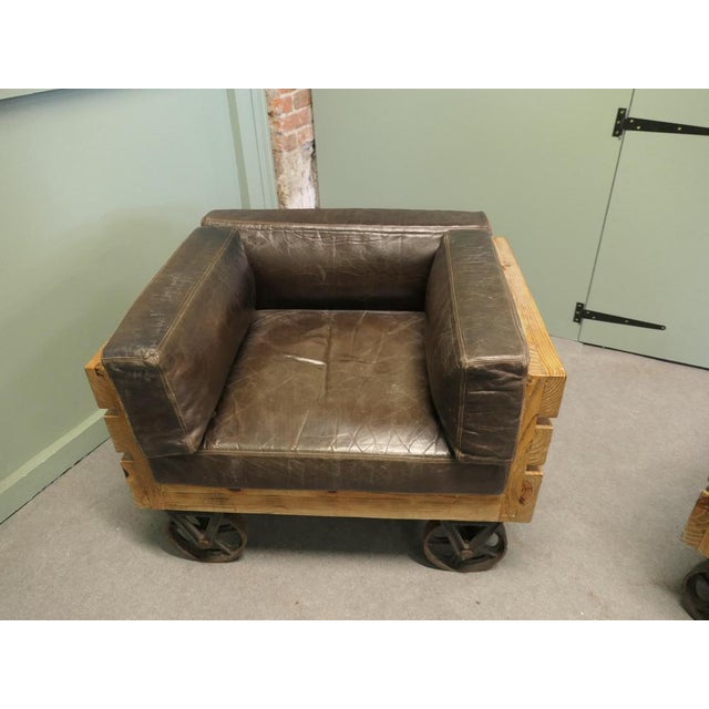 A Unique Set of 4 Wood Framed Industrial Club Chairs The chairs have Solid Wooden Frames and are set on cast iron railway...