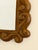 Mirror with a carved wooden frame, adorned with a relief scrollwork design around its entire perimeter. Its symmetrical...