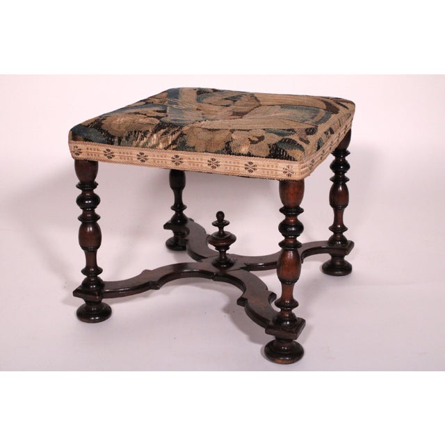 Antique William and Mary style walnut bench, 19th century. With an 18th century tapestry seat, baluster and ring turned...