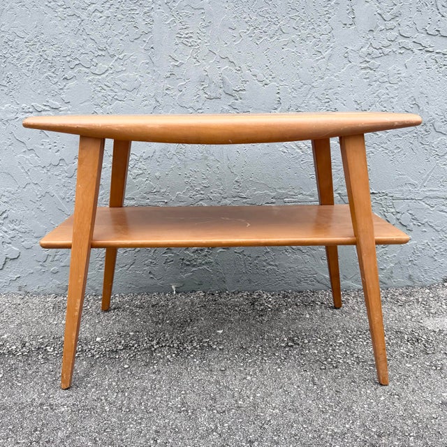 Classic vintage Heywood-Wakefield two-tier table featuring the streamlined simplicity and warm blonde wood finish...