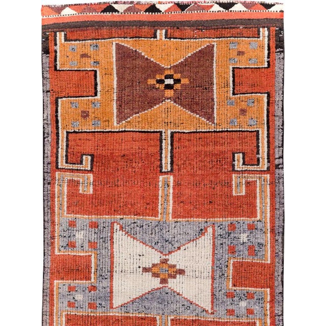 This mid-20th-century Turkish Anatolian tribal runner presents a bold, architectural composition built from four large...