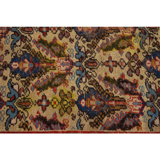 This exquisite Antique hand knotted Agra wool rug features a brown color field accented by blue and rust motifs in a...