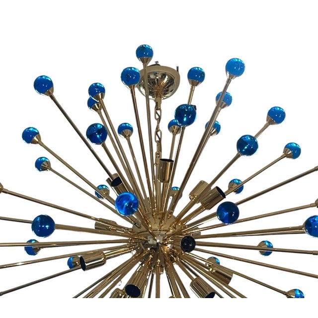 Beautiful Italian Sputnik chandelier featuring numerous hand-blown cobalt blue Murano glass spheres radiating from a...