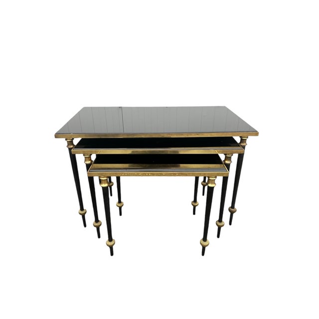 Set of three original 1950s nesting tables in brass and black opaline glass Small: 43 x 37 cm, height 35 cm Medium: 57 x...