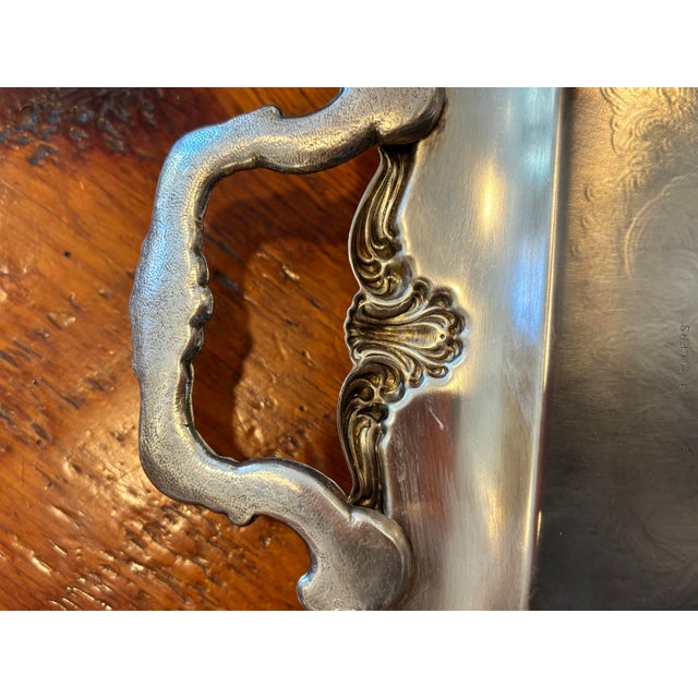 Lovely, long rectangular, silver plate, serving tray with ornate handles and beautiful detailing. 21” long handles by...