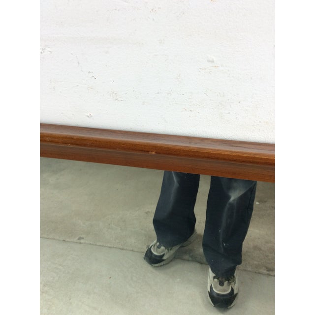 This mid century modern mirror features long rectangular design, hardwood frame with original walnut finish, and solid...