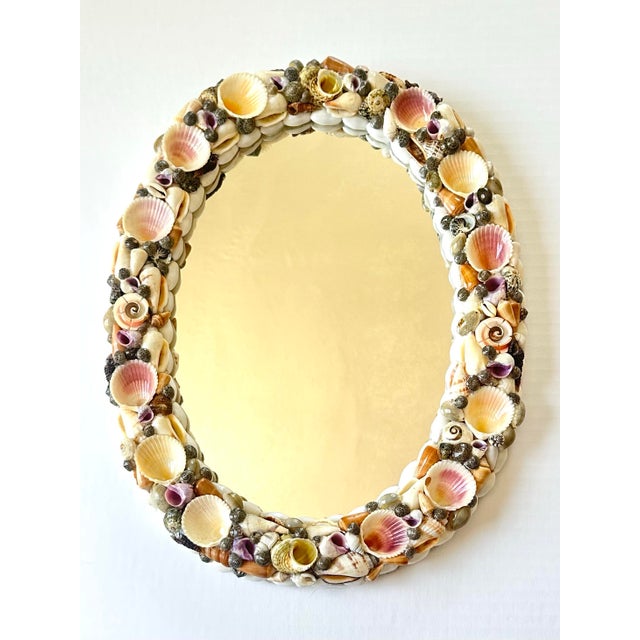 Bring a little piece of the shore indoors with this charming vintage oval mirror, its frame lovingly handcrafted from...