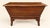 A solid oak chest from the english arts & crafts period, early 20th century. Its inverted trapezoidal shape—wider at the...