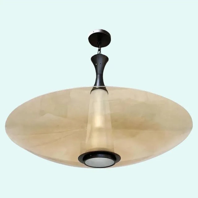 Italian modern chandelier or flush mount shown with smoked amber curved Murano glass shade with a beveled edge and frosted...