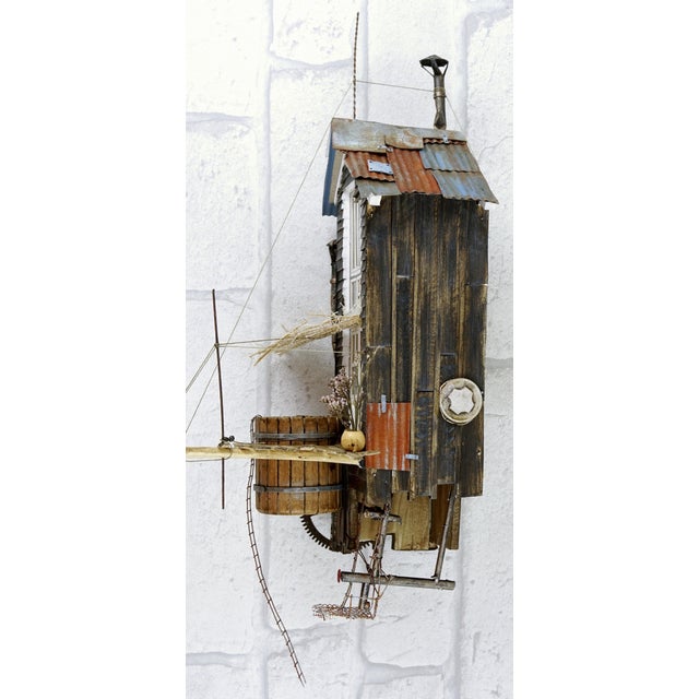 This singular work by David Mansot depicts a suspended Nordic Cabin, a meticulously handcrafted assemblage of reclaimed...