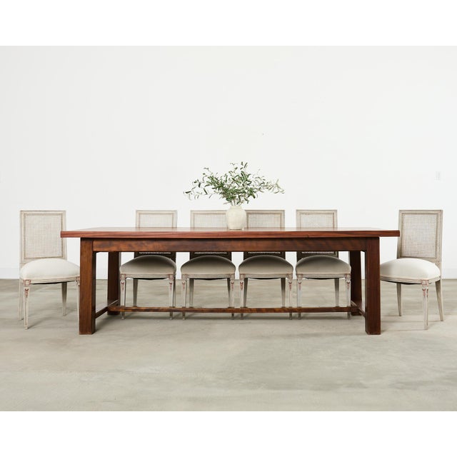 Gorgeous 20th century country French farmhouse dining table featuring a rare mahogany construction. The table has a 2 inch...