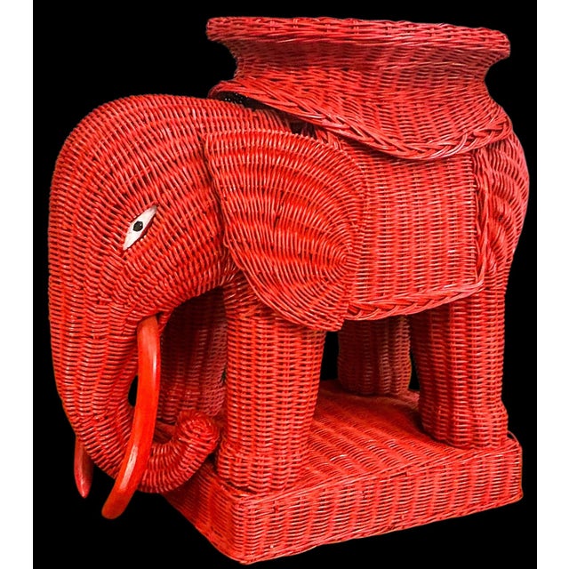 This is a fun Chinese Export style wicker elephant form garden stool or side table. The red is not original. The tail is a...