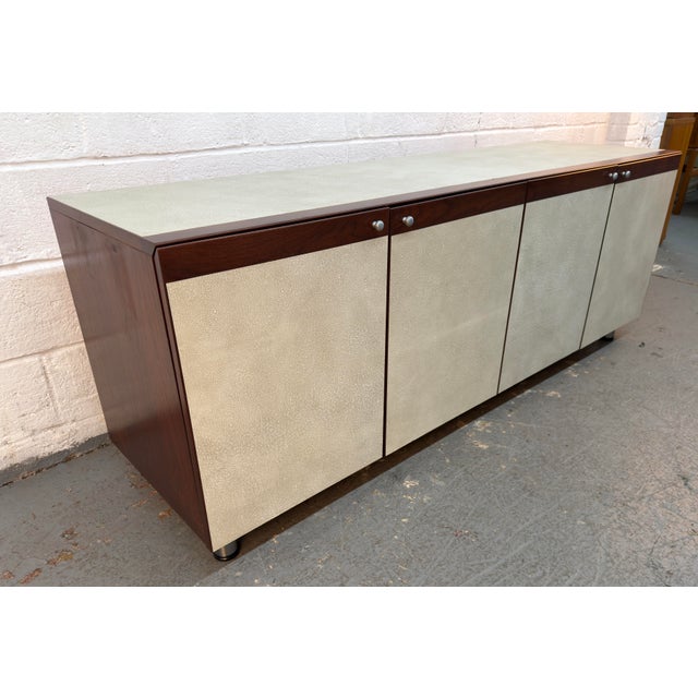 Stylish Mid-Century Modern style office credenza featuring a warm wood-grain finish, clean lines, and generous storage....