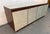 Stylish Mid-Century Modern style office credenza featuring a warm wood-grain finish, clean lines, and generous storage....