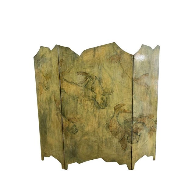 A stylish three fold asymmetrical plywood screen of Japanese style painted Koi carp moving against a swirling green water...