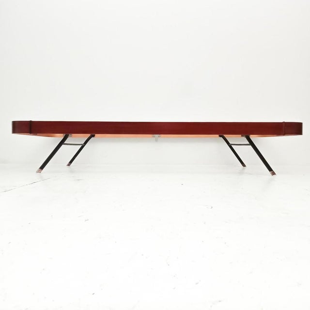 Italian-made single bed from the 1960s. The bed is complete with bed base, made of teak veneered plywood with metal legs...