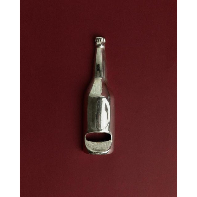 This vintage silver-plated bottle opener from the 1970s features a charming bottle-shaped design, combining playful retro...