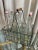 Vintage set of six Italian glass bottles and metal caddie with wood handle.
