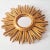 Beautiful gilded sunburst mirror from the 1960s This striking mirror is designed in the shape of a stylized sun. The round...