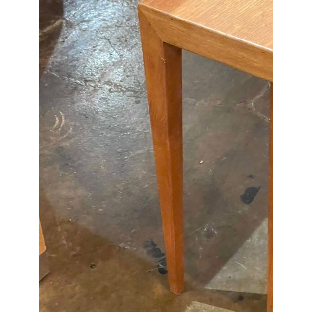 This set of vintage Danish oak nesting tables exudes mid 20th-century charm with its original design and warm brown color....