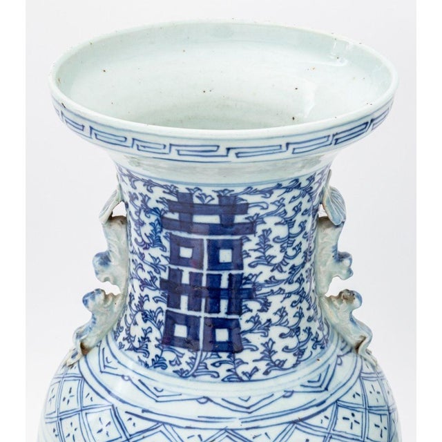 Pair of Chinese Blue and White Porcelain Baluster Vases, each with double foo lion handles to the neck and hand-painted...