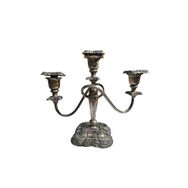 Elevate your table setting or mantelpiece with this exquisite vintage silver-plated candelabra, a timeless embodiment of...