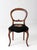 An antique late 19th-century Victorian balloon-back chair with a carved wood frame, cabriole front legs, and black floral...