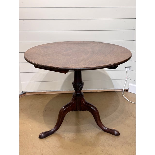 This is an excellent 19th century mahogany tilt top table with a hand turned pedestal, and three cabriole legs resting on...