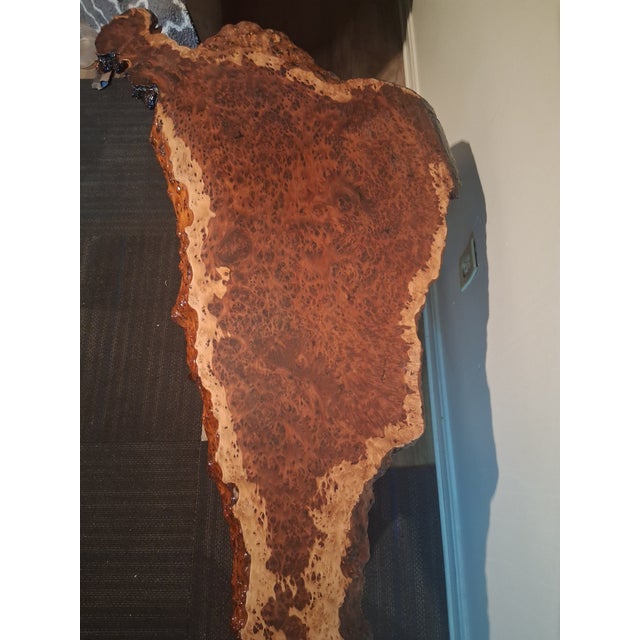 An exceptional mid-century organic modern coffee table featuring a highly figured, live-edge California redwood burl slab....