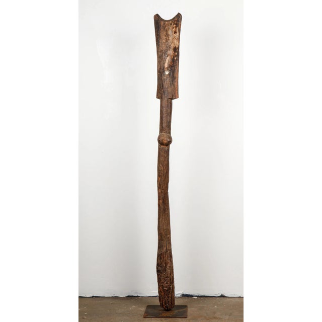 An early to mid-20th century antique Toguna support post or totem on a custom black iron base. Hand-carved wood in a Dogon...