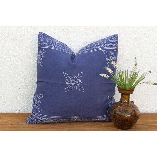 An eight-point star medallion, hand block-printed in white, radiates across a deep indigo linen ground on this pillow —...