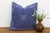 An eight-point star medallion, hand block-printed in white, radiates across a deep indigo linen ground on this pillow —...