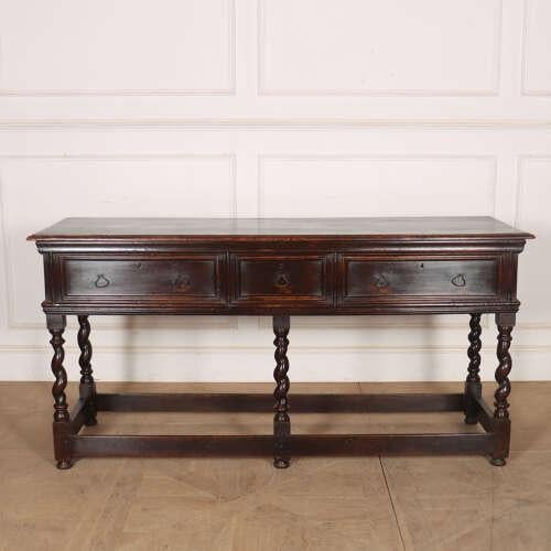 Early 18th century English oak dresser on barley twist legs with good colour. 1730. This piece is designed in the style of...