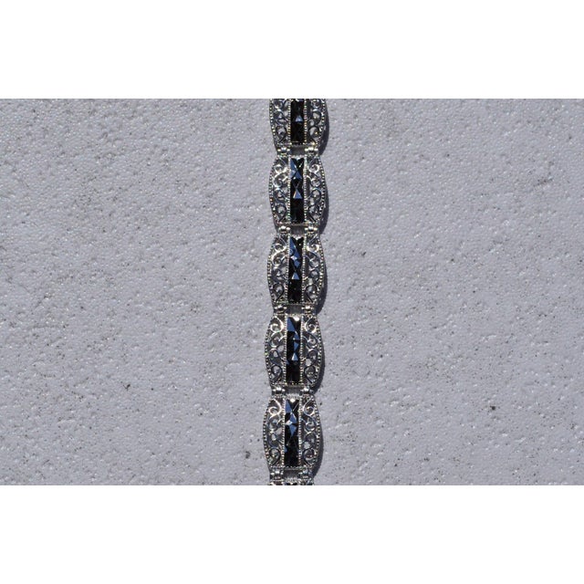 The Youngsville: White Gold Diamond Cut Bracelet. The bracelet features barrel shaped links with a central diamond cut row...