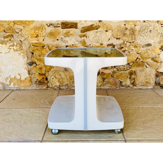 Vintage, mid-century side table / bar table with storage, by Flair, circa 1970s. The structure is made of white ivory-...