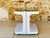 Vintage, mid-century side table / bar table with storage, by Flair, circa 1970s. The structure is made of white ivory-...