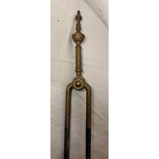 Up for sale is a nice pair of rare antique 18th century wrought iron and brass English fireplace tongs. The arms are...