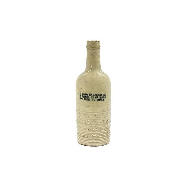 Antique English laundry ammonia bottle. Heavy stoneware with underglaze lettering. Lettering has some blurring during...