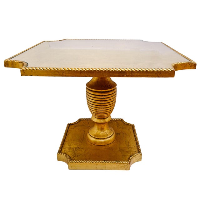 A striking vintage Italian pedestal side table featuring a square top with notched corners, a hand-gilded rope-twist...