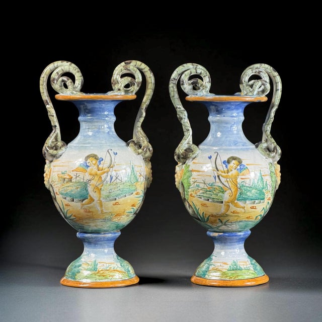 An exceptional pair of Italian hand-painted majolica vases dating to the late 19th century. The elegant baluster-shaped...