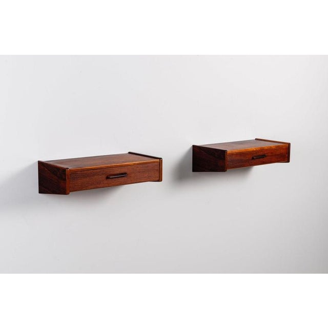 A refined pair of Scandinavian floating nightstands made in Denmark during the 1960s. Crafted in richly figured Santos...