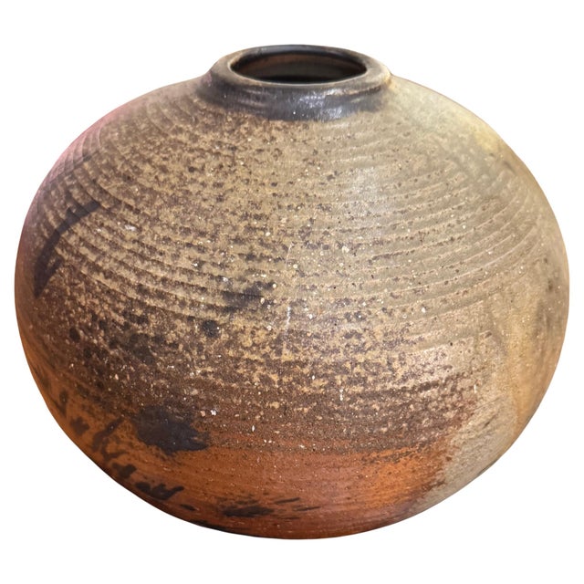 Earthy, tactile, and powerfully understated, this large hand-thrown stoneware orb exemplifies the iconic aesthetic of...