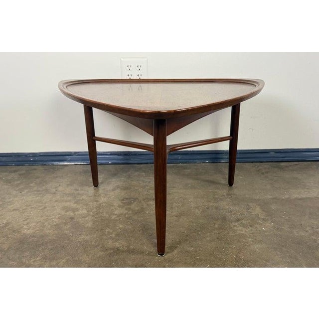 A striking example of Danish Modern design, this sculptural walnut coffee table dates to the late 1950s or early 1960s and...