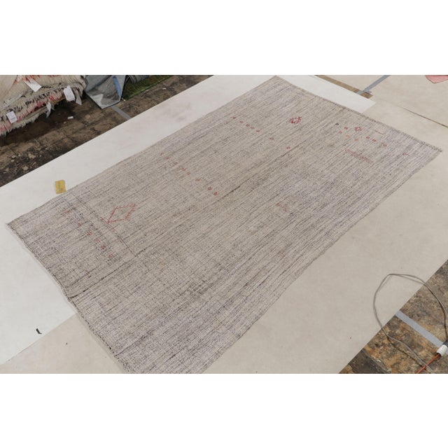 Hand woven in wool originating from one of our most reputed looms in Turkey, this modern striped Kilim rug hails from the...