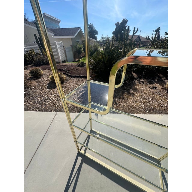 We have for your consideration a very gorgeous brass plated vintage mid century modern postmodern etagere. This etagere...