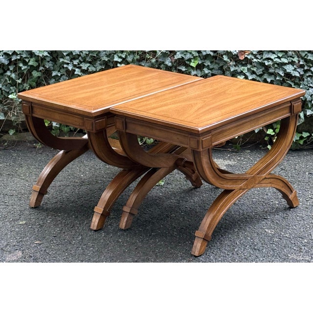 Beautiful pair of vintage campaign-style benches featuring striking sculptural X-form bases with gracefully curved legs...