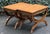 Beautiful pair of vintage campaign-style benches featuring striking sculptural X-form bases with gracefully curved legs...