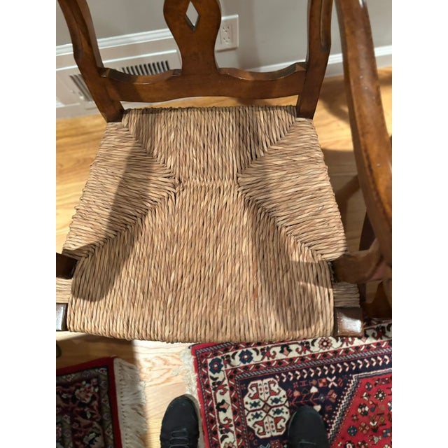 This is a pair of French country style walnut chairs with rush seats. Unknown date of manufacture. The chairs are in mint...