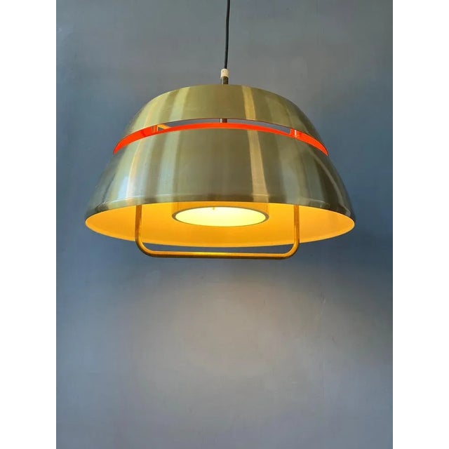 Orange Mid-Century pendant lamp by Lakro Amstelveen. The lamp is made out of steel and has an orange lacquer from the...