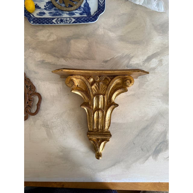 This vintage Italian wall sconce shelf features classic Florentine-style carving with elegant acanthus scrolls and a warm...